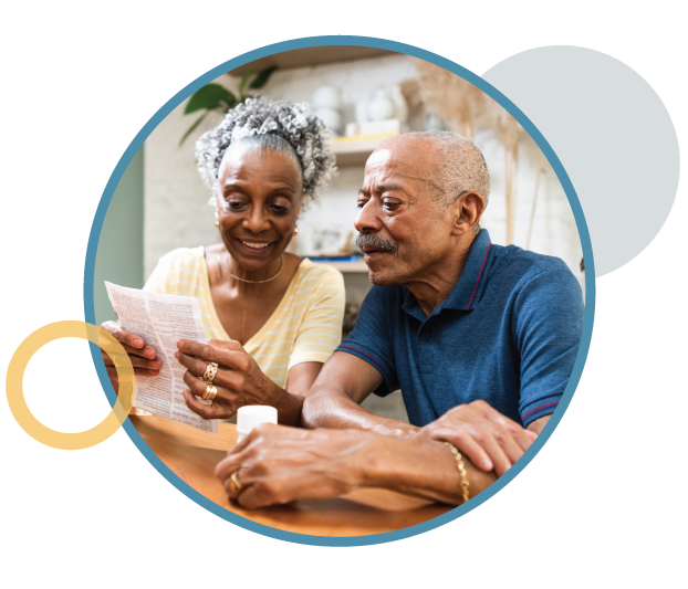An older couple reading a document.